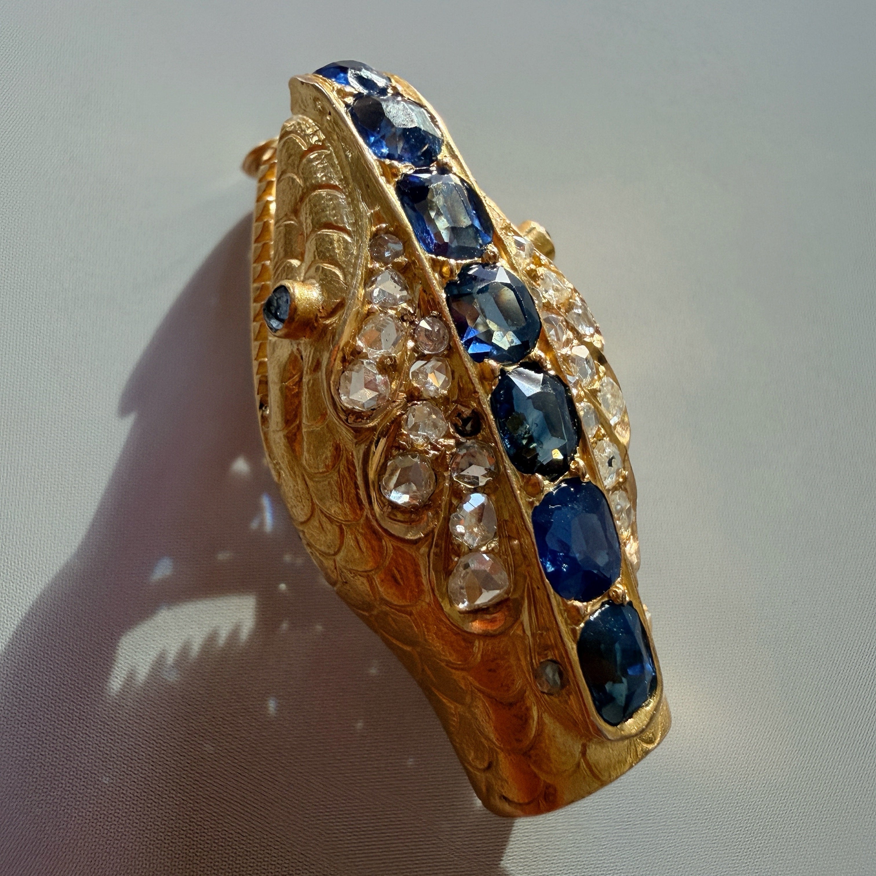 Antique 18K gold blue sapphire diamond snake head brooch