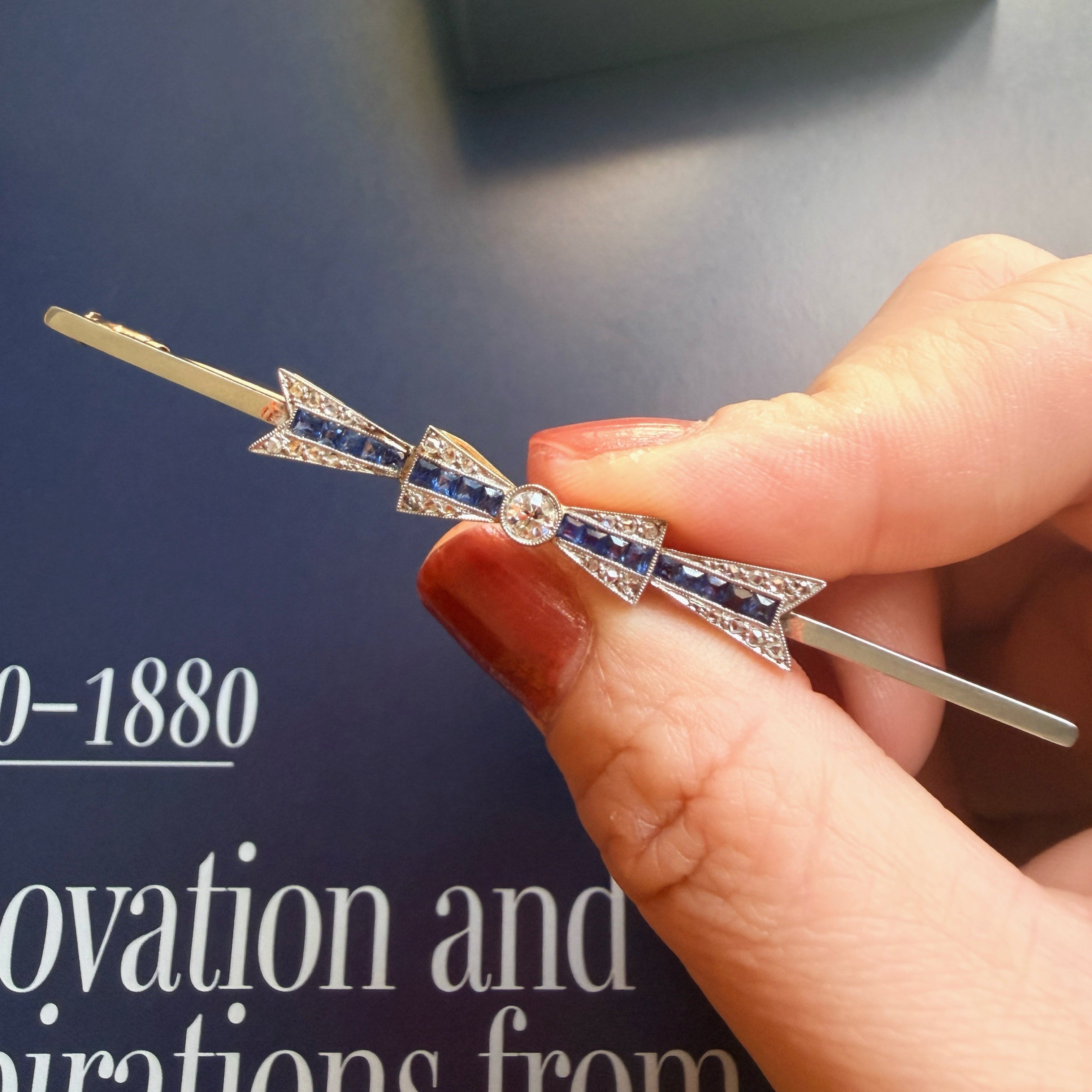 Art Deco 18K gold diamond sapphire bow brooch