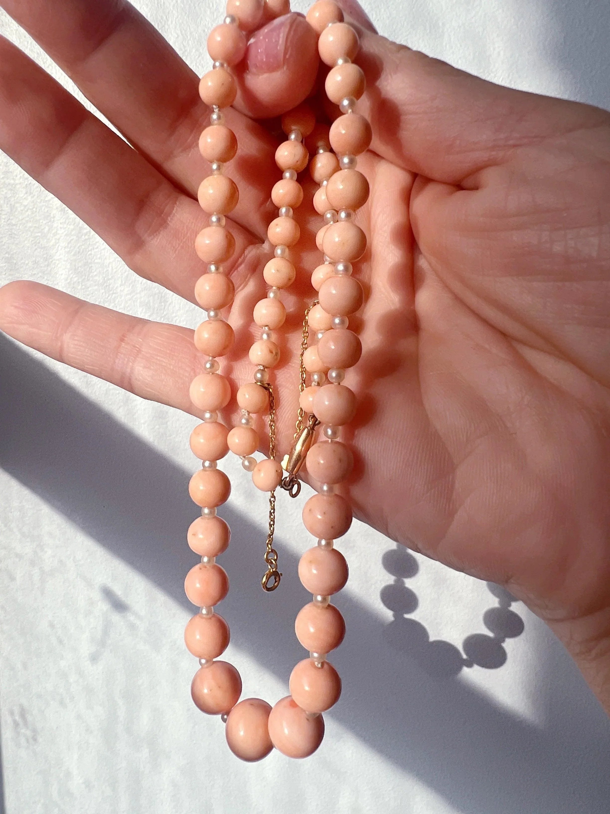 18K gold graduated natural angel skin pink coral pearl necklace - Curiously timeless
