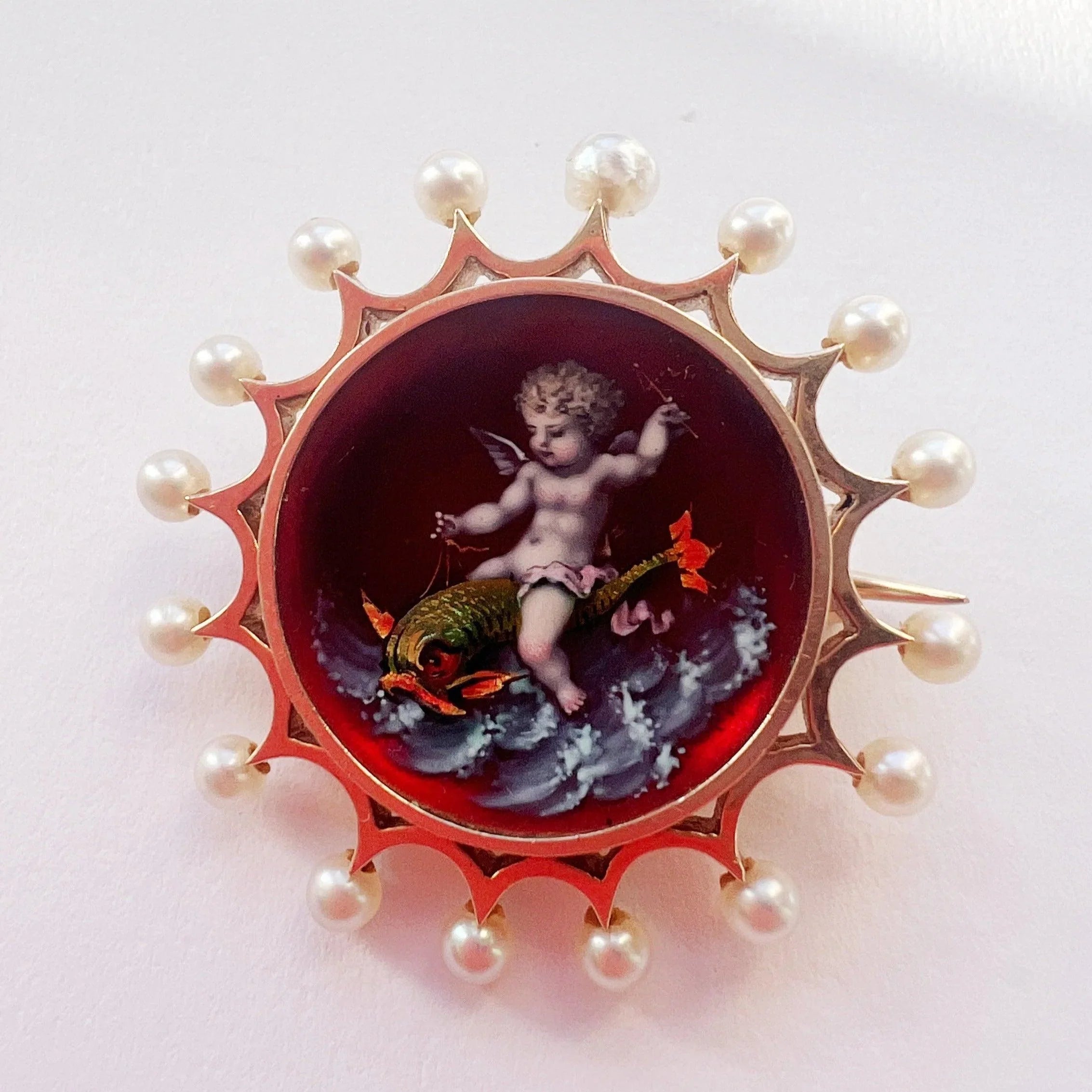Victorian era 18K gold pearl enamel cupid riding a dolphin brooch - Curiously timeless