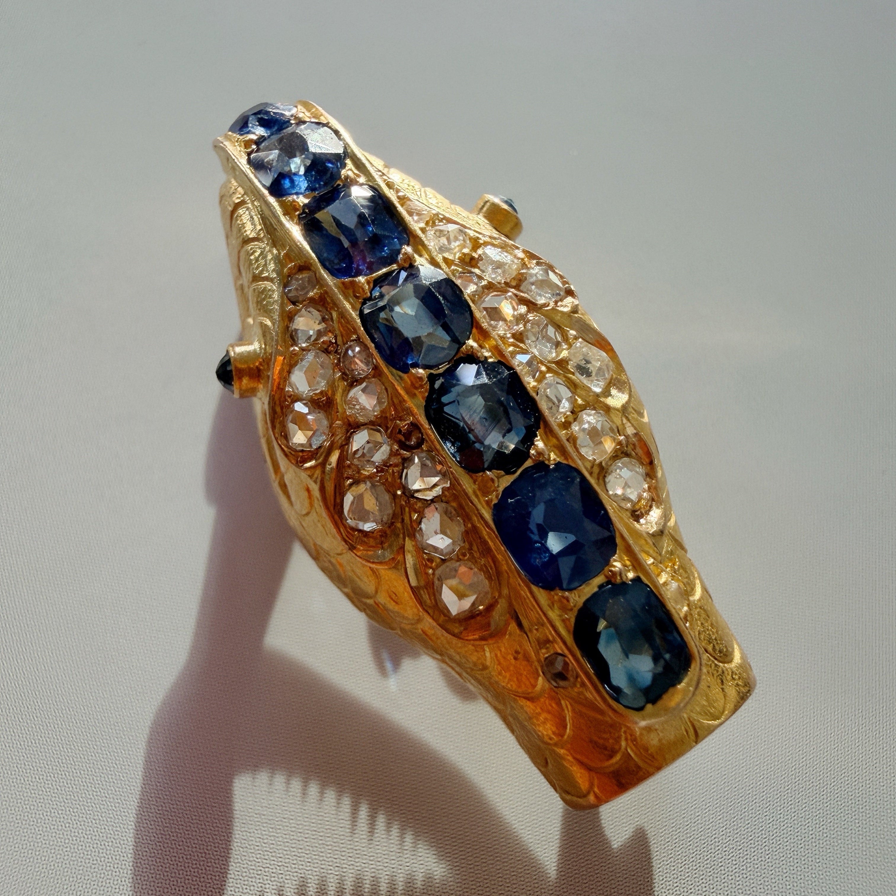 Antique 18K gold blue sapphire diamond snake head brooch