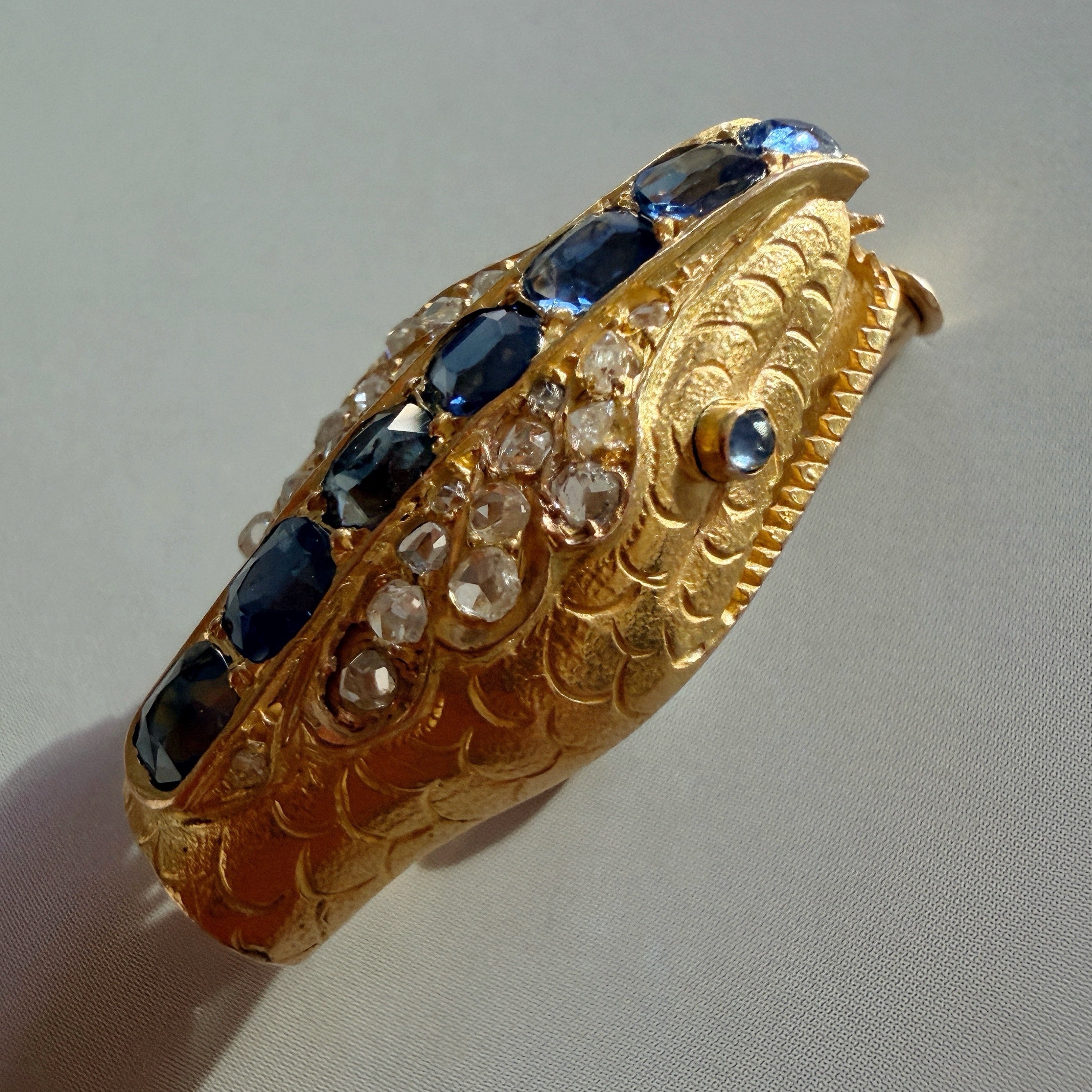 Antique 18K gold blue sapphire diamond snake head brooch