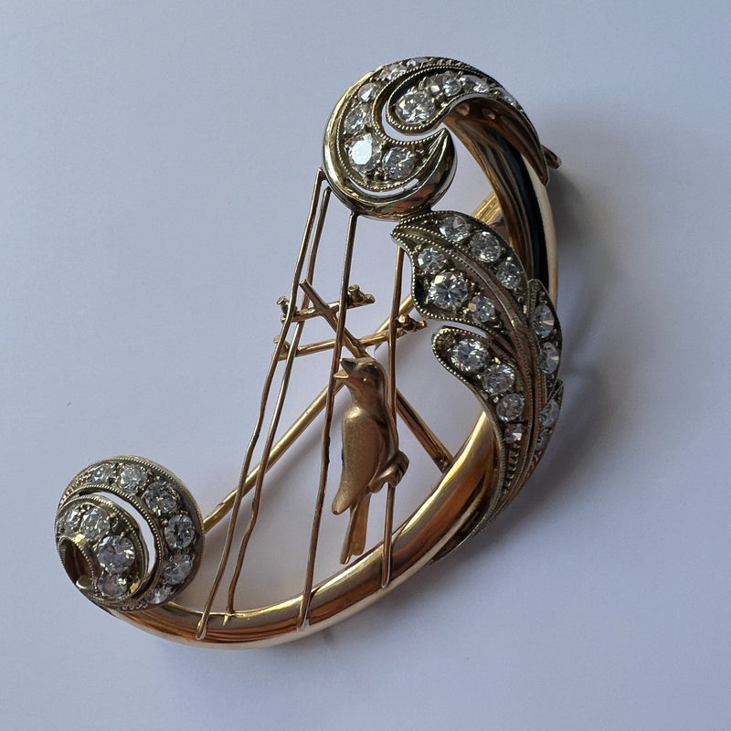 Vintage 18K gold diamond bird singing on a harp brooch