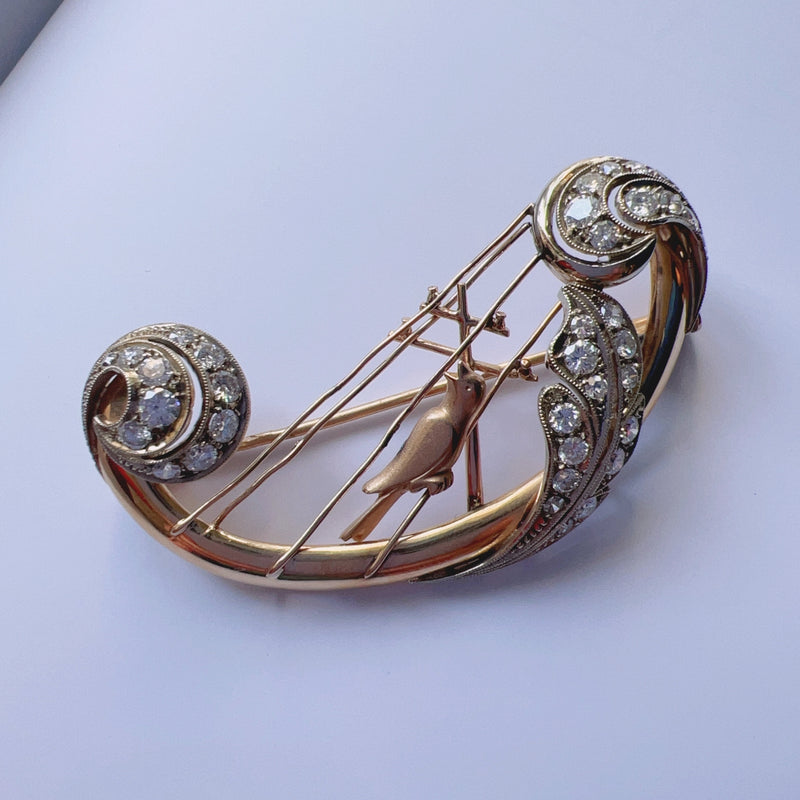 Vintage 18K gold diamond bird singing on a harp brooch