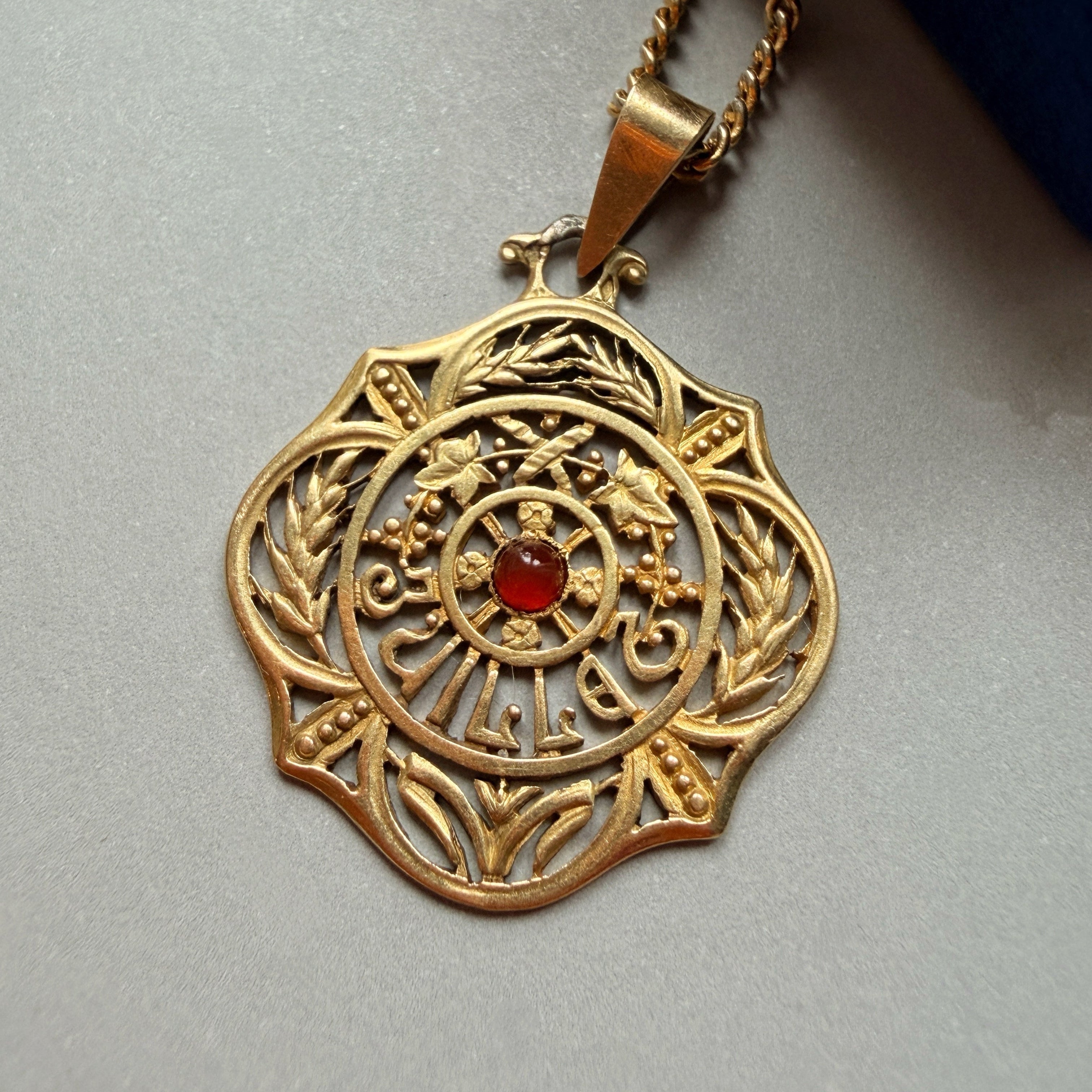 Art Nouveau era 18K gold “July” medal pendant