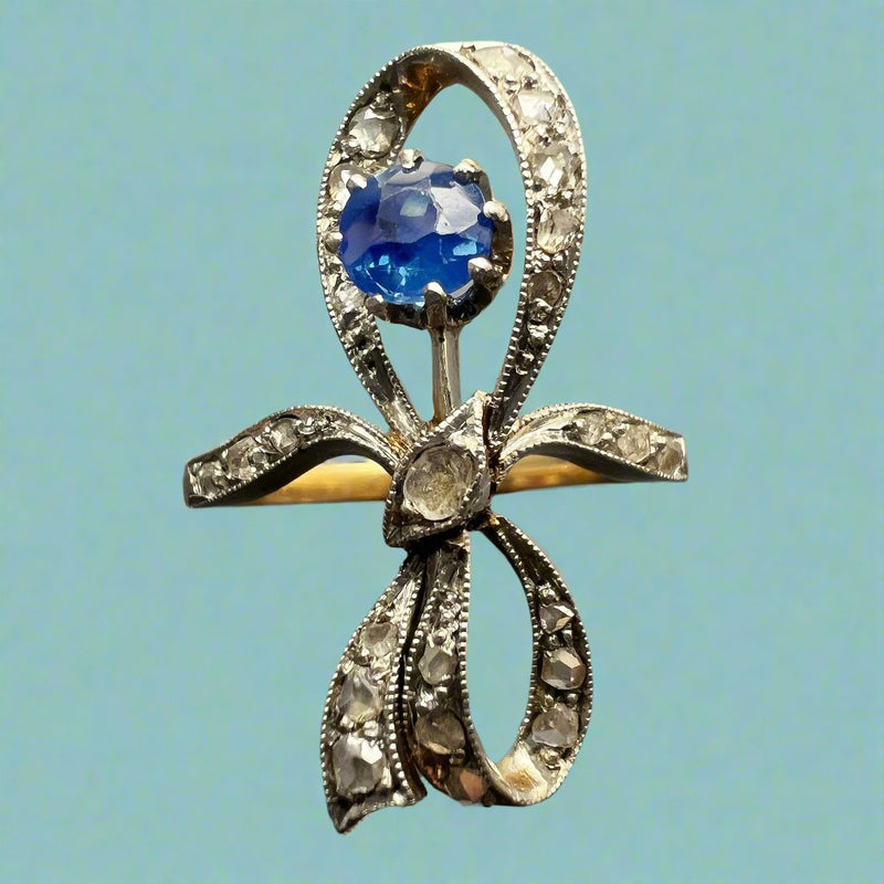 Edwardian era 18K gold blue sapphire bow ring