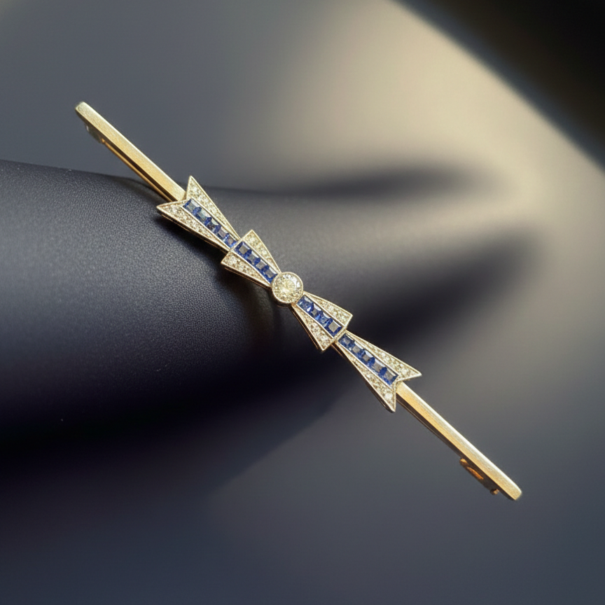 Art Deco 18K gold diamond sapphire bow brooch