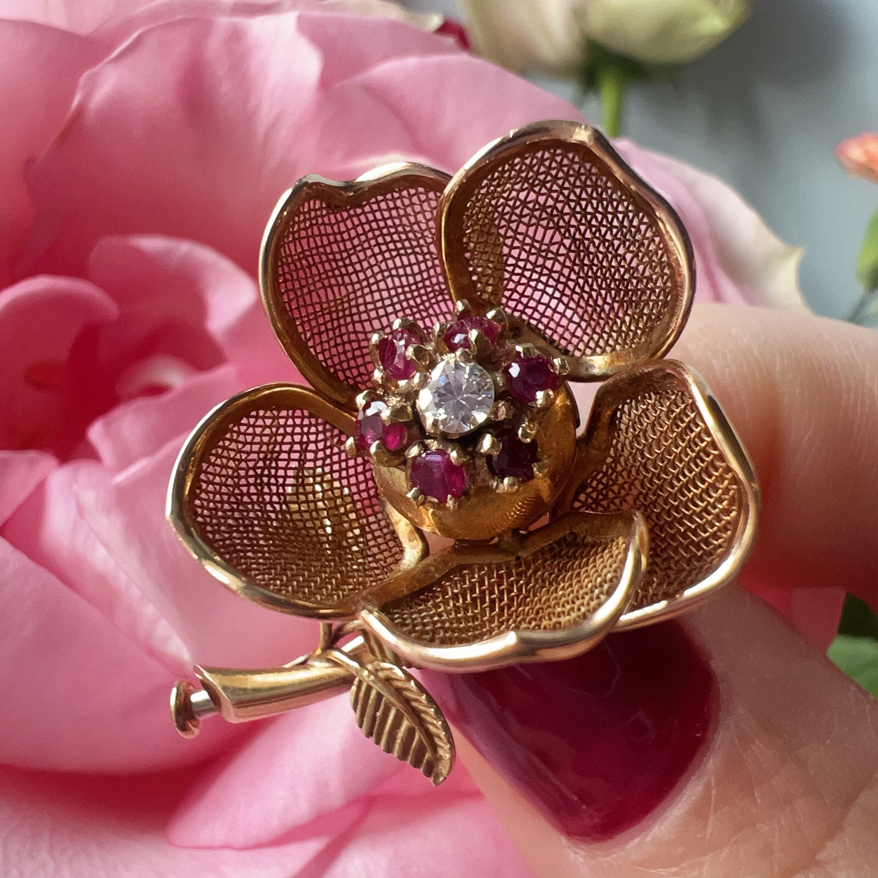 Vintage 18K gold opening rose brooch with articulated petals