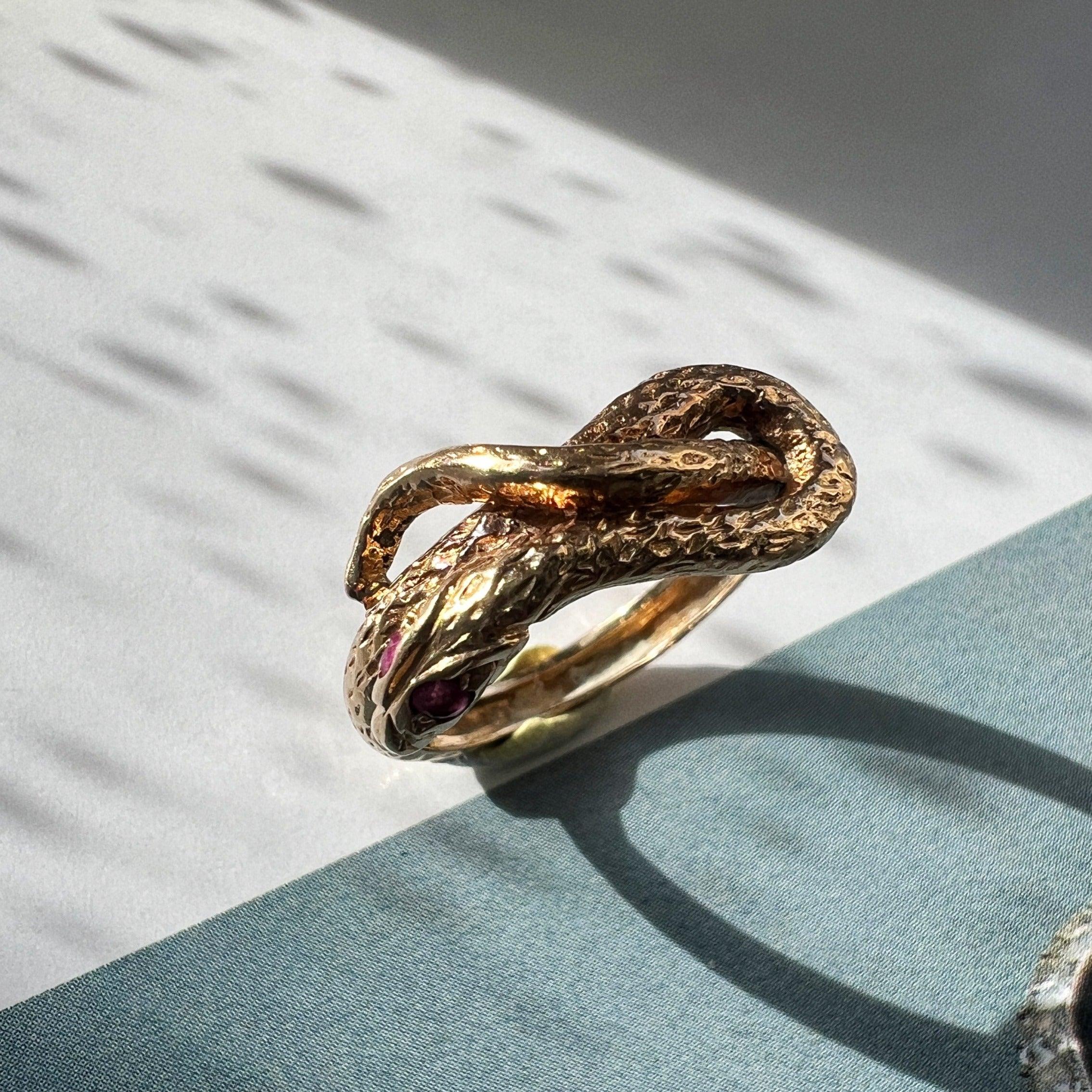 Chiseled 18k yellow plain gold twisted snake ring with ruby eyes - Curiously timeless