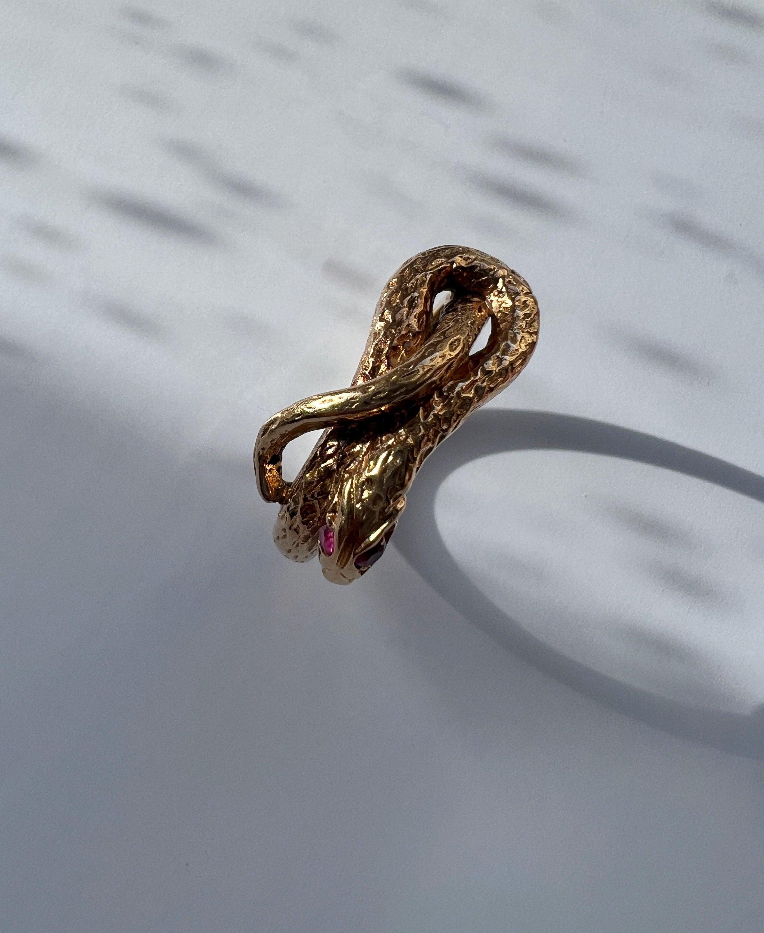 Chiseled 18k yellow plain gold twisted snake ring with ruby eyes - Curiously timeless