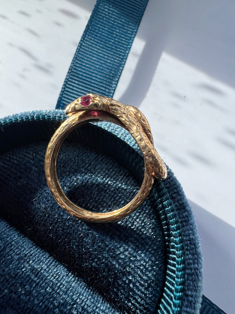 Chiseled 18k yellow plain gold twisted snake ring with ruby eyes